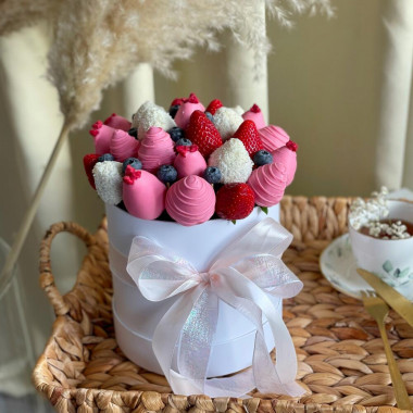 Клубника в белом и розовом шоколаде в шляпной коробке с ягодами голубики